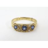 An 18ct gold ring set with three topaz and four diamonds. The ring approx size N Please Note - we do