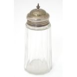 A cut glass sugar shaker with silver lid, hallmarked Birmingham 1909, maker C&C Ltd.?. Approx. 5 1/