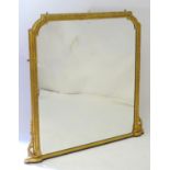 A mid / late 19thC giltwood and gesso mantle mirror with floral mouldings and bead work