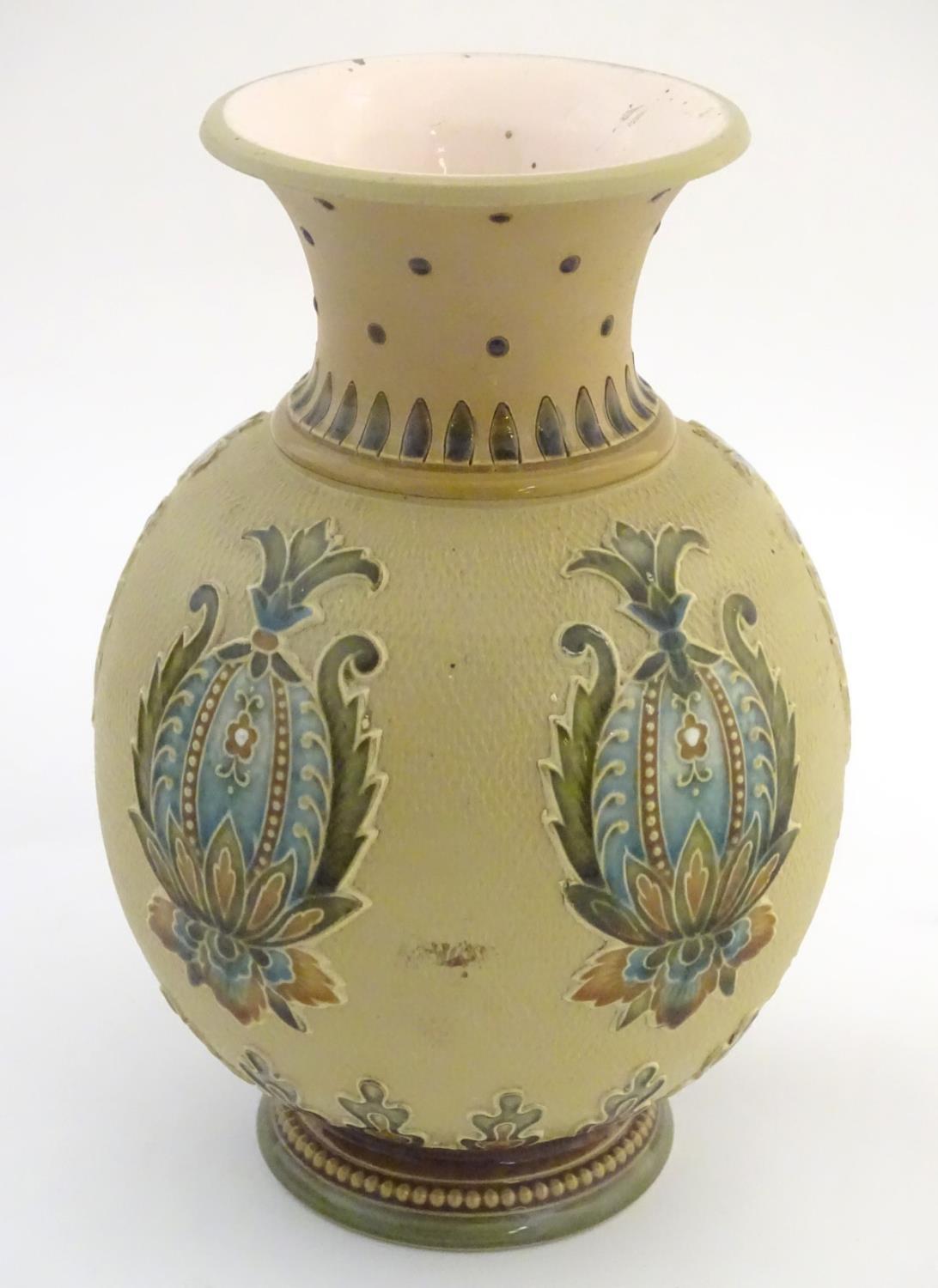 A Mettlach vase with a flared rim and bulbous body, decorated with sylised floral and foliate motifs