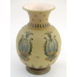 A Mettlach vase with a flared rim and bulbous body, decorated with sylised floral and foliate motifs