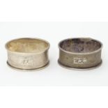 A pair of silver napkin rings with engine turned decoration. hallmarked Birmingham 1952 maker F H