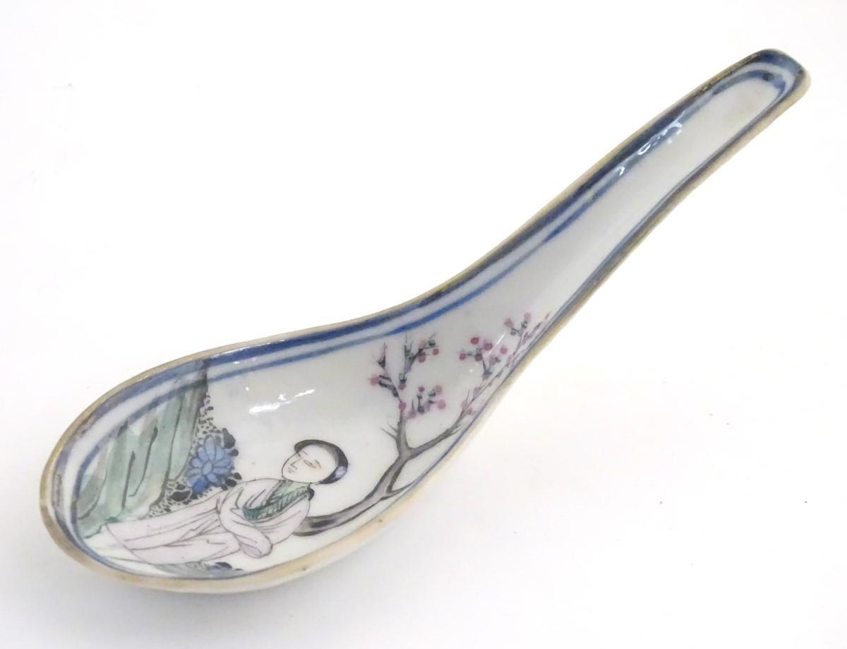 A Chinese famille rose soup spoon decorated with a figure in a landscape with a cherry blossom tree. - Image 2 of 14