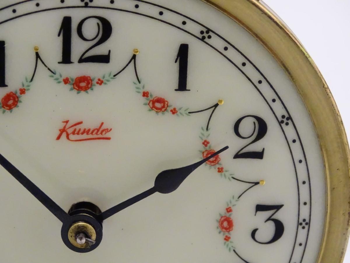 A mid 20thC 'Kundo' anniversary clock with a glass dome above a brass frame. 12" high. Please Note - - Image 3 of 13