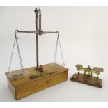 An early 20thC set of Crown postage scales, of brass construction on an oak base with 2oz, 1oz and