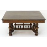 A 20thC oak table with a rectangular moulded top, four turned tapering legs with fluted decoration