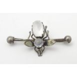 A late 19thC / early 20thC white metal brooch with winged insect to centre set with moonstone