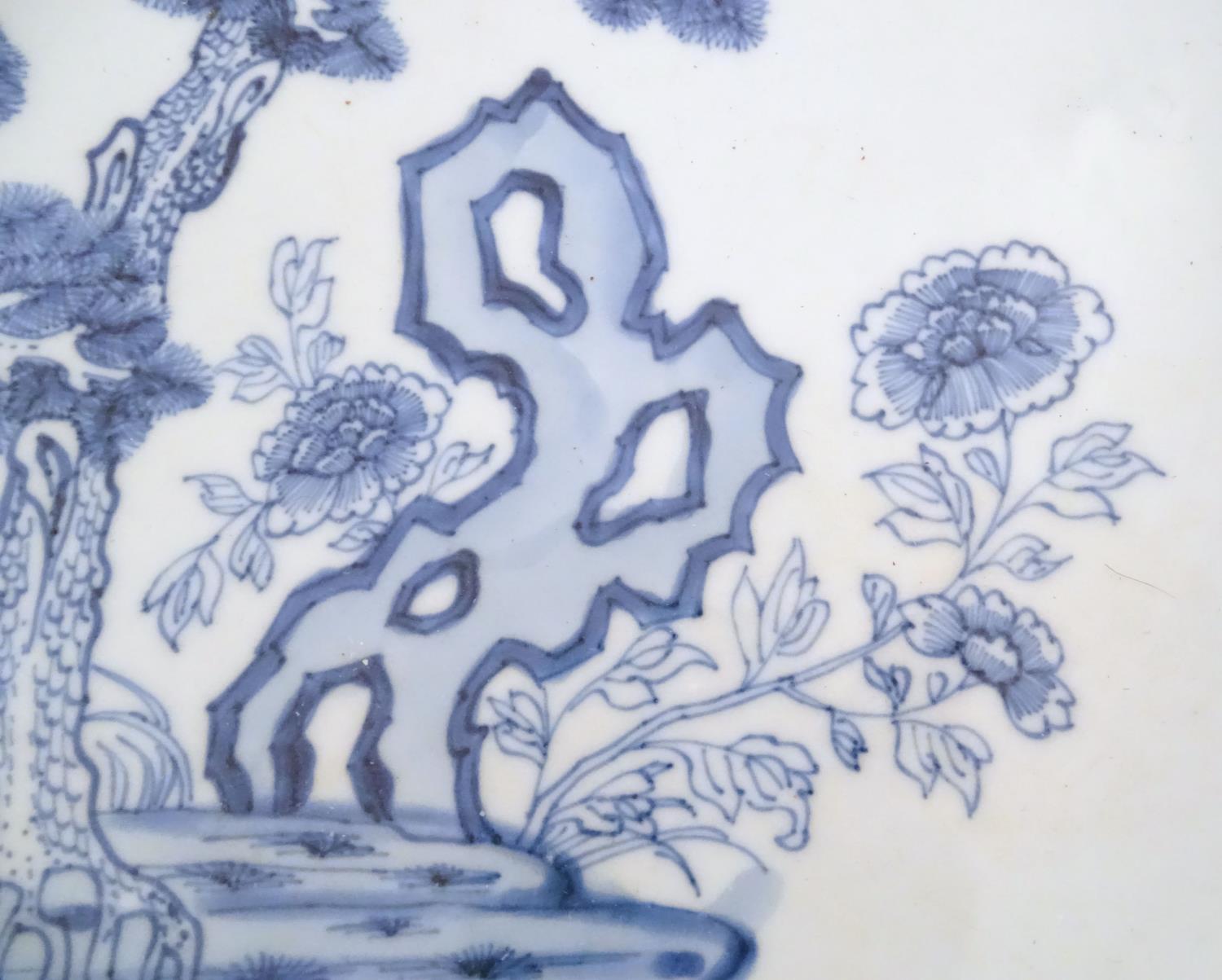 A Chinese blue and white charger decorated with a stylised landscape with trees and flowers, and a - Image 15 of 21