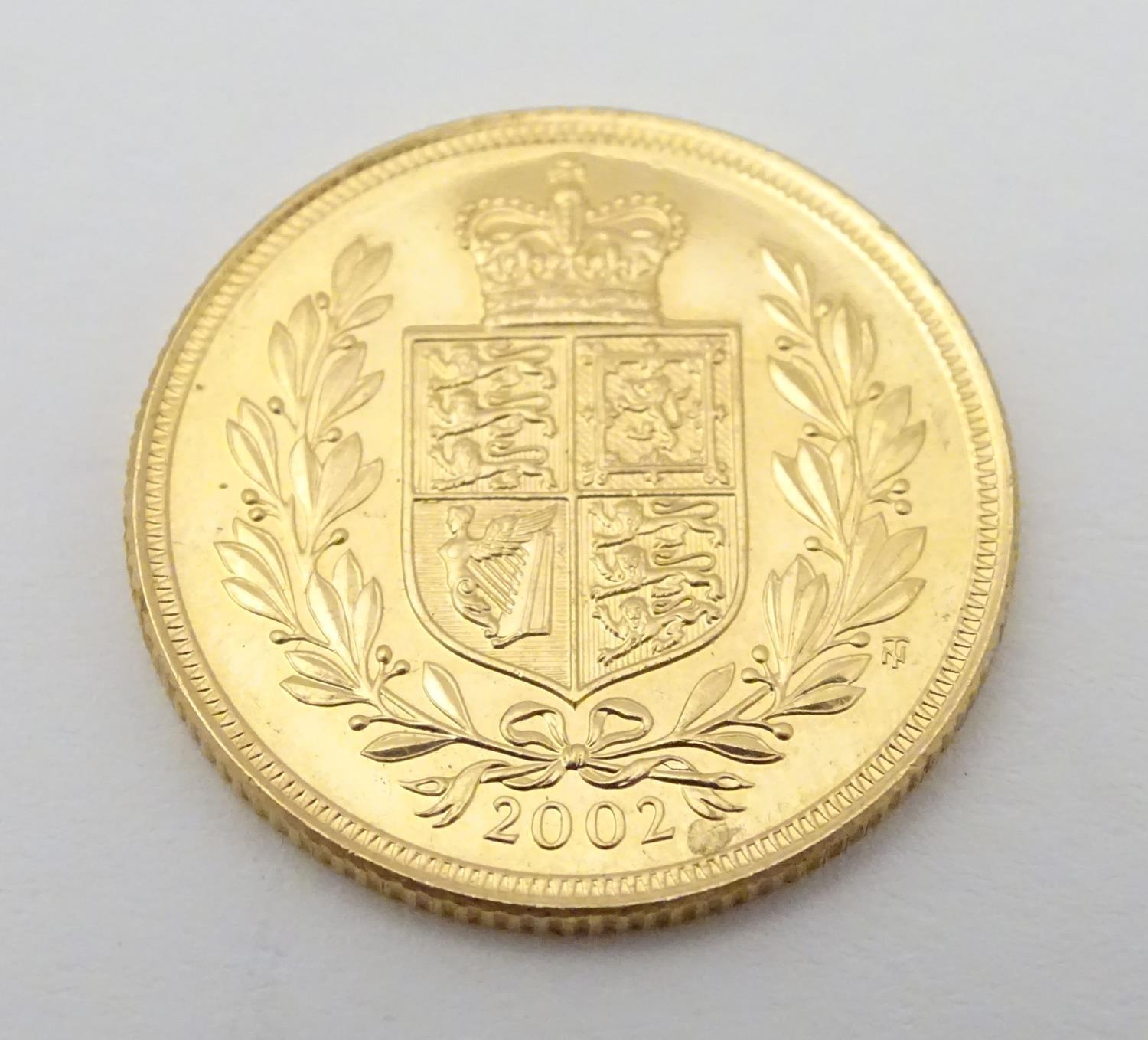 A 2002 gold Elizabeth II sovereign coin. Approx. weight 8g Please Note - we do not make reference to - Image 8 of 10