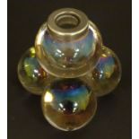 An unusual glass toothpick holder / inkwell, formed as stacked spheres with marbled irridescent