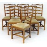 A set of six early 19thC mahogany Chippendale style ladder back dining chairs, with a drop in seat