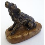 A late 19th / early 20thC cast model of a seated dog mounted upon a base. Approx. 5 1/2" high Please