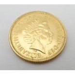 A 2002 gold Elizabeth II sovereign coin. Approx. weight 8g Please Note - we do not make reference to