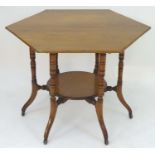 A late 19thC walnut Aesthetic movement table with a hexagonal top above six ring turned legs with