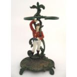 A 20thC cast and enamel painted stick stand, the upright formed as a male figure situated among