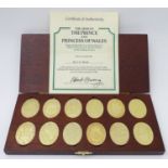 A cased collection of gold plated sterling silver oval ingots, Danbury Mint c1981, a limited edition
