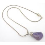 A pedant set with polish amethyst hard stone specimen, on chain. The whole approx 16" long Please