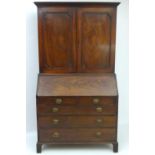 A George III mahogany bureau bookcase, with checkered decoration to the top and base. The bookcase