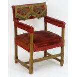 A 20thC open armchair with an upholstered backrest, seat and arms, having a chamfered frame and