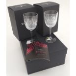 A boxed pair of Waterford Crystal 'Lismore' white wine glasses with diamond cut decoration, each