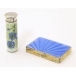 A silver lipstick holder with guilloche enamel decoration and hand painted corn flower detail,