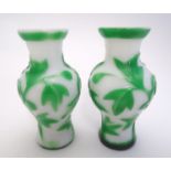 A pair of mid 19thC Peking glass small vases decorated with rhododendron. Each 3 3/4" tall Please
