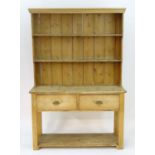 A Victorian pine dresser with a moulded cornice above two shelves and a peg jointed base