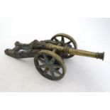 Militaria: an early-20thC Eastern model / desk cannon, the barrel of cast brass with lion's mask