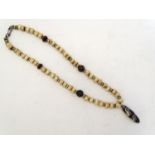 A bone and hardstone bead necklace. Approx. 21" long Please Note - we do not make reference to the