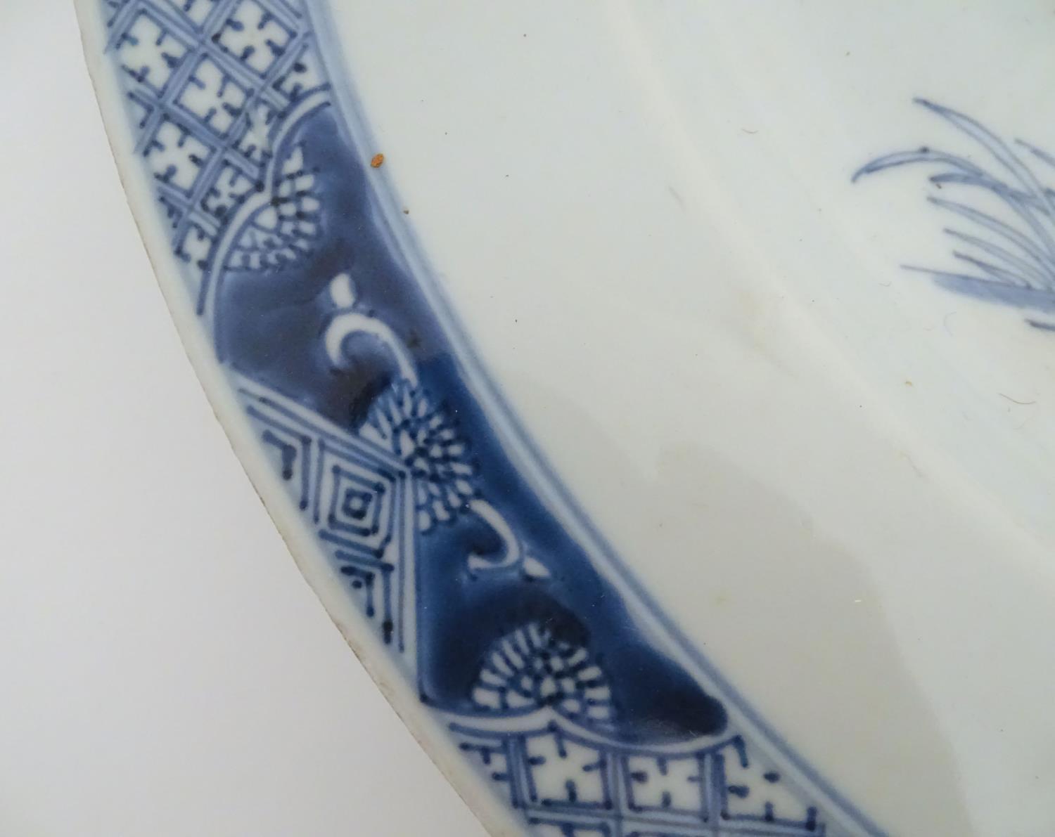 A Chinese blue and white charger decorated with a stylised landscape with trees and flowers, and a - Image 19 of 21