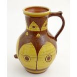 A large earthenware studio pottery baluster vase / jug with single handle, with a brown ground