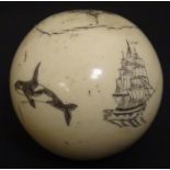 A late 19th / early 20thC sphere / ball with later scrimshaw decoration depicting narwharls, a