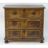 A late 17thC oak chest with a rectangular planked top and moulded edges above three long drawers