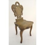 A mid 20thC music box in the form of a chair, the back rest having carved pierced decoration and