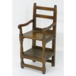 A rare early 18thC mixed wood childs chair, the back uprights having carved terminals above a