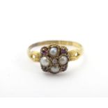 A Victorian 18ct gold ring set with central simaond borderedby pearls and rubies. Ring size approx