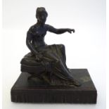 A 19thC bronze figure of a woman seated on an x-frame stool mounted on a fringed rectangular base.