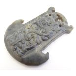 A carved jade pendant / toggle with stylised animal decoration. Approx. 3" long. Please Note - we do