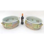 A pair of Chinese foot baths, the exterior decorated with landscape hunting scenes with figures with