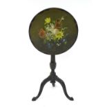 An early 20thC slate top table with a still life floral scene painted on the top, having a