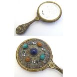 A 19thC gilt metal miniature hand mirror with applied hardstone cabochons and enamel flower