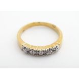 A gilt metal ring set with 5 chip set diamonds. Ring size approx. Q Please Note - we do not make