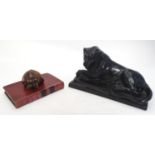 A 20thC large desk paper weight formed as a recumbent lion on a rectangular base. Together with a
