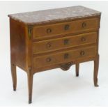 An early / mid 20thC marble topped commode with canted corners above inlaid drawers with ring pull