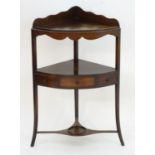 A 19thC mahogany corner washstand with a shaped upstand above two tiers, the lower tier having a
