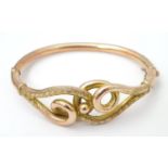 An early 20thC 9ct gold bracelet of bangle form with scrolling detail . Hallmarked Birmingham 1909