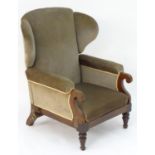 A Victorian wingback adjustable armchair with scrolled arms, mechanical crank to one side and raised