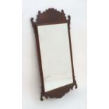 A 20thC mahogany framed mirror, with Georgian style carved borders, 39 1/2" tall, 22 1/4" wide