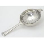 An Art Deco silver tea strainer, hallmarked London 1945, maker Edward Barnard & Sons Ltd. Approx.