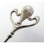 An Art Nouveau silver hat pin hallmarked Birmingham 1909, maker P & V. 11" long Please Note - we